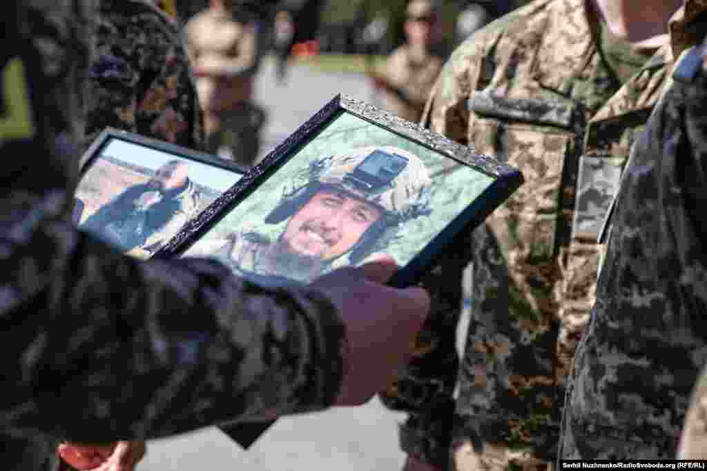 Побратим тримає прижиттєві світлини бійців: на них Сергій та Тарас під час служби &ndash; усміхнені та емоційні. В цей момент близькі не стримують сліз, стоячи біля їхніх трун