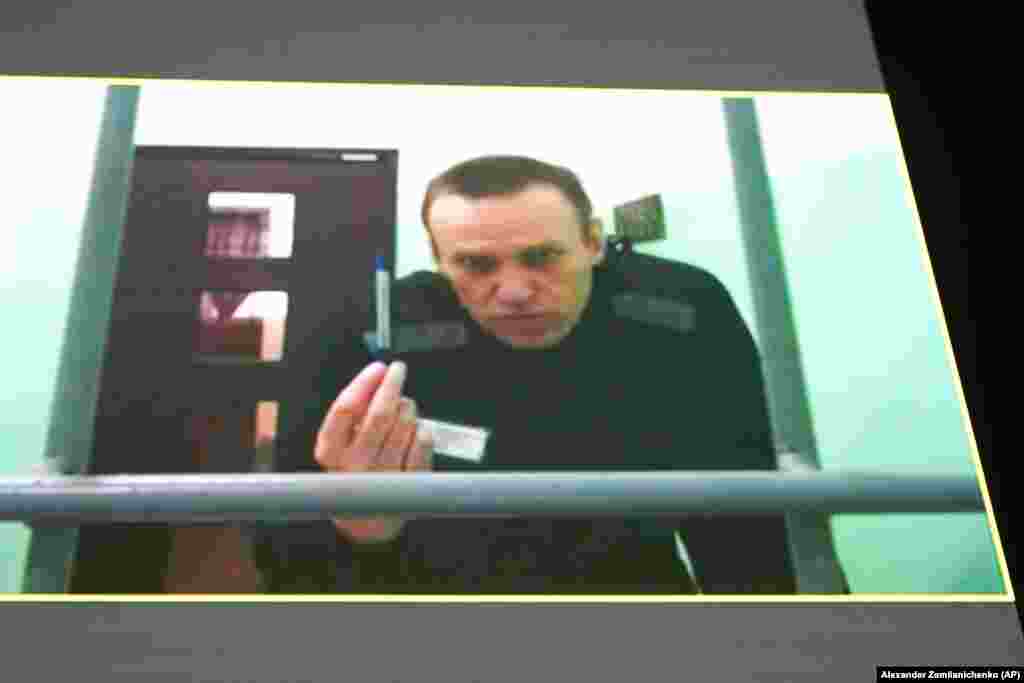 Російський опозиційний лідер Олексій Навальний на екрані телевізора під час відеозв'язку, наданого Федеральною службою виконання покарань Росії з колонії в Мелехово Володимирської області, під час слухання у Верховному суді Росії в Москві. Росія, 22 червня 2023 року. Навальний подав позов, оскаржуючи тюремні правила, які, за його словами, дозволяють тюремникам позбавляти його канцелярського приладдя і ручок, порушуючи тим самим його право подавати на них скарги. (AP Photo/Alexander Zemlianichenko)