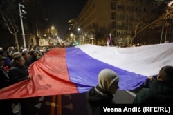 A Russian flag is unfurled at the far-right protest in Belgrade over the government's policy toward Kosovo on February 15.