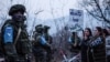 Nagorno-Karabakh - Azerbaijani protesters stand in front of Russian peacekeepers on a road outside Stepanakert, December 24, 2022. 