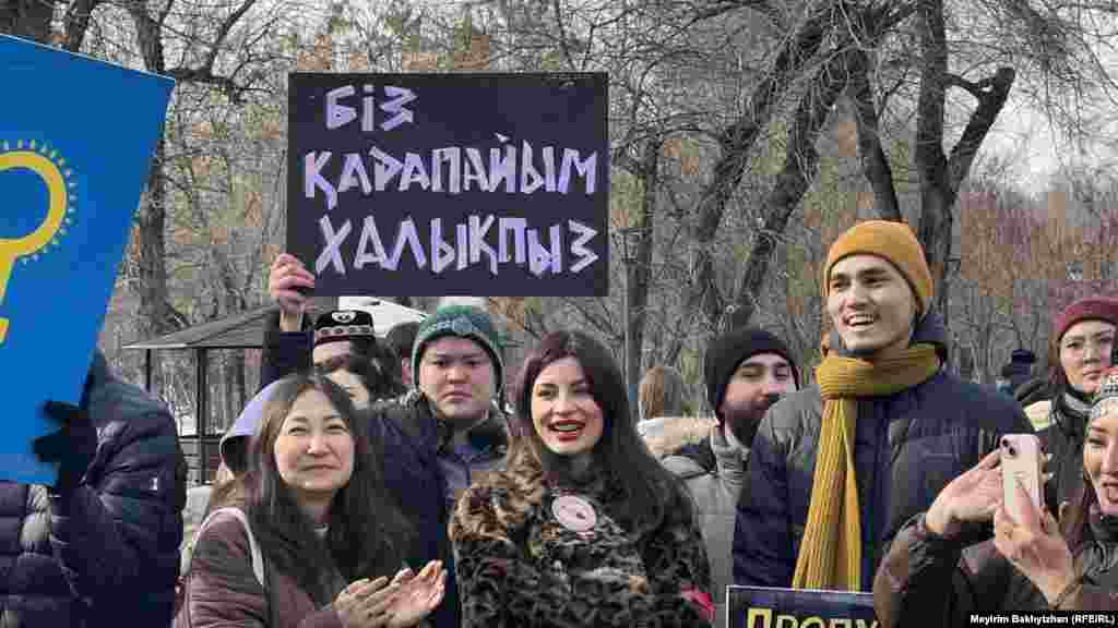 Мужчина держит плакат с надписью: «Біз қарапайым халықпыз» («Мы простой народ»). Эта надпись созвучна с надписью на растяжке, которая была у участников мирного митинга 6 января 2022 года на площади Республики во время кровопролитных Январских событий. В тот день, согласно свидетельствам очевидцев, силовики стреляли по находившимся в этом месте мирным демонстрантам