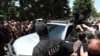 Armenia - Masked security officers are confronted by angry followers of the Armenian Apostolic Church in Echmiadzin, June 27, 2025.
