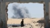 Displaced Palestinians make their way as they flee the eastern part of Khan Younis