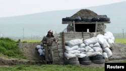 Nagorno-Karabakh -- An ethnic Armenian soldier stands guard at the checkpoint near Nagorno-Karabakh's town of Martuni, April 8, 2016