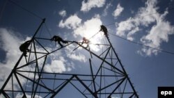 Afghanistan -- Afghan electricity workers set up electricity poles in the Padkhab district of the Logar province, February 20, 2015
