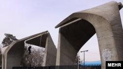 Iran -- A man cleans entrance gateway of Tehran University, Tehran, 03Jan2010 