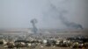 SYRIA -- Smoke rises over the Syrian town of Ras al-Ain, October 11, 2019