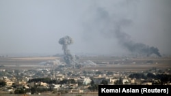 SYRIA -- Smoke rises over the Syrian town of Ras al-Ain, October 11, 2019