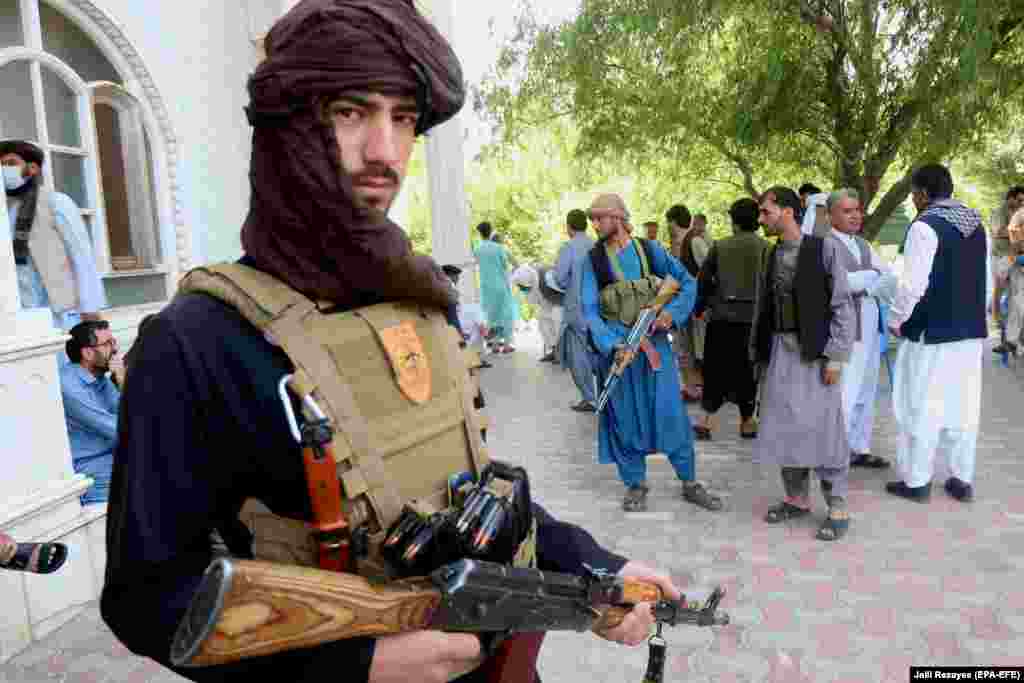 Armed supporters of former mujahedin commander Ismail Khan guard his residence on July 9. Khan and his followers have vowed to fight alongside Afghan security forces against the Taliban as the militants advance into the western Herat Province. 