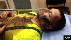 Ukraine -- A TV grab shows opposition activist Dmytro Bulatov lying down while receiving medical attention in Kyiv, January 1, 2014