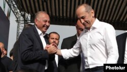 Armenia - Former President Robert Kocharian (R) greets Armen Charchian, director of the Izmirlian Medical Center, during a rally in Yerevan, May 9, 2021.