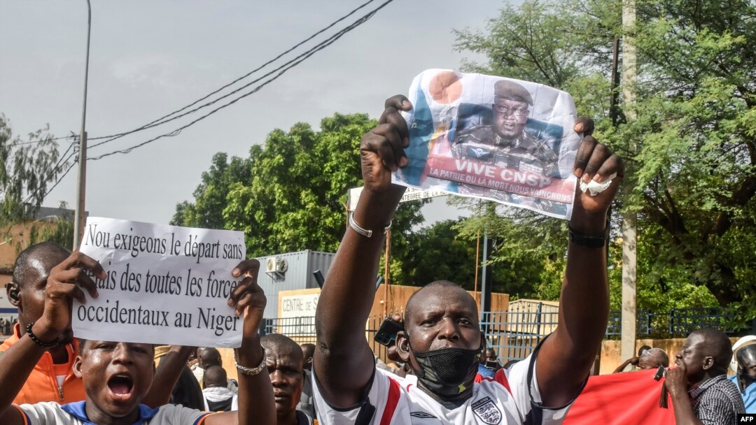 Un susținător ține o fotografie a generalului Abdourahamane Tiani, șeful puternicei gărzi prezidențiale care a preluat puterea în Niger.